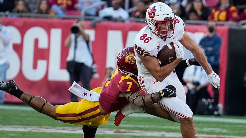 Oct 9, 2021; Los Angeles, California, USA; USC Trojans safety Chase Williams (7) makes a diving tackle on Utah Utes tight end Dalton Kincaid (86) during the second quarter at United Airlines Field at Los Angeles Memorial Coliseum. Mandatory Credit: Robert Hanashiro-USA TODAY Sports