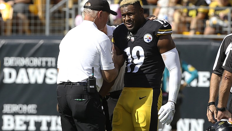 Oct 10, 2021; Pittsburgh, Pennsylvania, USA;  Pittsburgh Steelers team orthopedic doctor James Bradley (left) looks at the right arm of Pittsburgh Steelers wide receiver JuJu Smith-Schuster (19) after Smith-Schuster suffered an apparent injury against the Denver Broncos during the second quarter at Heinz Field. Smith-Schuster  would leave the game. Mandatory Credit: Charles LeClaire-USA TODAY Sports