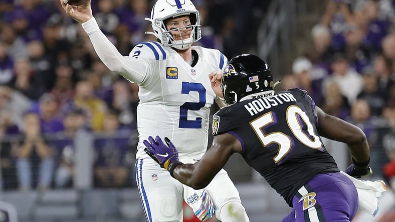 Oct 11, 2021; Baltimore, Maryland, USA; Indianapolis Colts quarterback Carson Wentz (2) passes the ball under pressure from Baltimore Ravens outside linebacker Justin Houston (50) during the first quarter at M&T Bank Stadium. Mandatory Credit: Geoff Burke-USA TODAY Sports