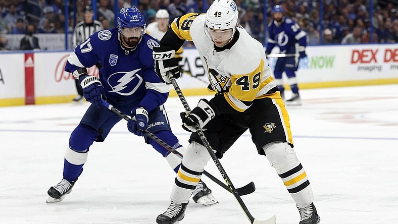 Oct 12, 2021; Tampa, Florida, USA; Pittsburgh Penguins center Dominik Simon (49) skates with the puck against Tampa Bay Lightning left wing Alex Killorn (17) during the third period at Amalie Arena. Mandatory Credit: Kim Klement-USA TODAY Sports