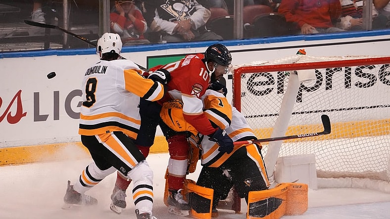 Oct 14, 2021; Sunrise, Florida, USA; Florida Panthers left wing Anthony Duclair (10) crashes into Pittsburgh Penguins goaltender Casey DeSmith (1) on the interference penalty of defenseman Brian Dumoulin (8)  during the first period at FLA Live Arena. Mandatory Credit: Jasen Vinlove-USA TODAY Sports