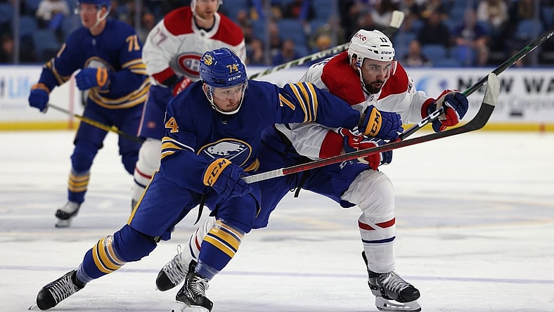 Oct 14, 2021; Buffalo, New York, USA;  Buffalo Sabres right wing Rasmus Asplund (74) and Montreal Canadiens center Cedric Paquette (13) go after a loose puck during the first period at KeyBank Center. Mandatory Credit: Timothy T. Ludwig-USA TODAY Sports