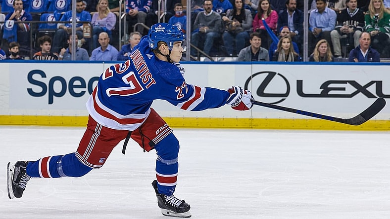 Oct 14, 2021; New York, New York, USA; New York Rangers defenseman Nils Lundkvist (27) shoots the puck against the Dallas Stars during the first period at Madison Square Garden. Mandatory Credit: Vincent Carchietta-USA TODAY Sports