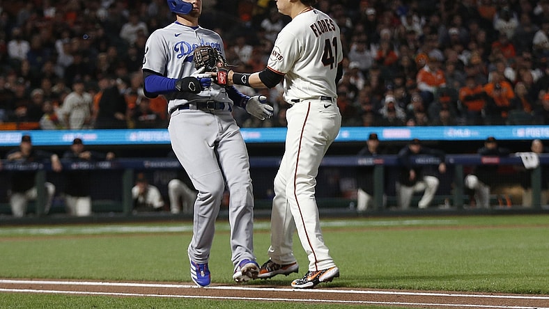 Oct 14, 2021; San Francisco, California, USA; San Francisco Giants first baseman Wilmer Flores (41) tags out Los Angeles Dodgers shortstop Corey Seager on a ground ball to first base in the fourth inning during game five of the 2021 NLDS at Oracle Park. Mandatory Credit: D. Ross Cameron-USA TODAY Sports