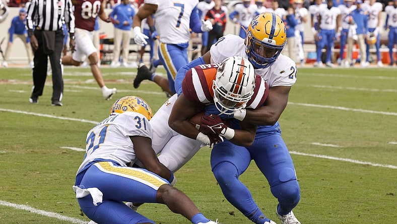 Oct 16, 2021; Blacksburg, Virginia, USA;  Virginia Tech Hokies running back Raheem Blackshear (5) is tackled by Pittsburgh Panthers defensive back Erick Hallett (31) and linebacker Wendell Davis (20) during the first quarter at Lane Stadium. Mandatory Credit: Reinhold Matay-USA TODAY Sports