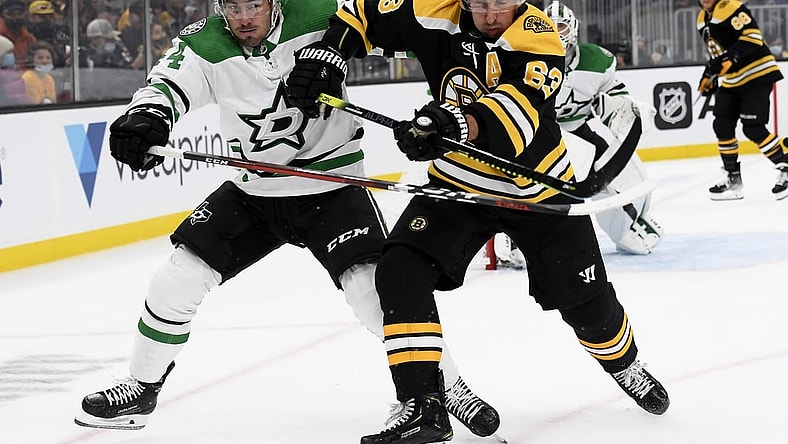 Oct 16, 2021; Boston, Massachusetts, USA;  Dallas Stars defenseman Joel Hanley (44) and Boston Bruins center Brad Marchand (63) battle for position during the first period at TD Garden. Mandatory Credit: Bob DeChiara-USA TODAY Sports