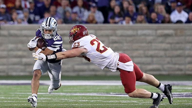Oct 16, 2021; Manhattan, Kansas, USA; Kansas State Wildcats running back Deuce Vaughn (22) runs against Iowa State Cyclones linebacker Mike Rose (23) during the first quarter at Bill Snyder Family Football Stadium. Mandatory Credit: Scott Sewell-USA TODAY Sports