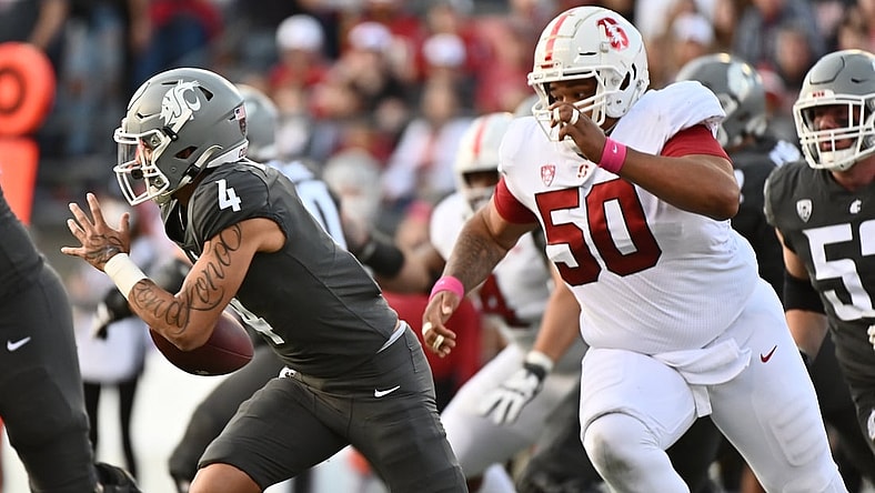 Oct 16, 2021; Pullman, Washington, USA; Washington State Cougars quarterback Jayden de Laura (4) is chased out of the pocket by Stanford Cardinal defensive tackle Dalyn Wade-Perry (50) in the first half at Gesa Field at Martin Stadium. Mandatory Credit: James Snook-USA TODAY Sports