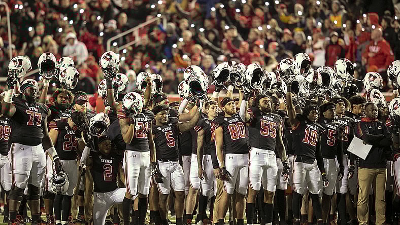 Oct 16, 2021; Salt Lake City, Utah, USA;  Utah Utes players raise their helmets and cheer during the fourth quarter break in a tribute to Aaron Lowe and Ty Jordan in a game against the Arizona State Sun Devils at Rice-Eccles Stadium. Mandatory Credit: Rob Gray-USA TODAY Sports