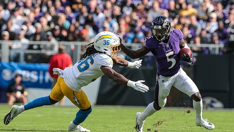 Oct 17, 2021; Baltimore, Maryland, USA; Baltimore Ravens wide receiver Marquise Brown (5) carries the ball as defensive back Trey Marshall (36) tackles during the first half at M&T Bank Stadium. Mandatory Credit: Vincent Carchietta-USA TODAY Sports
