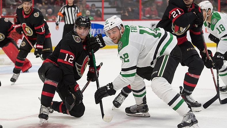 Oct 17, 2021; Ottawa, Ontario, CAN; Ottawa Senators center Shane Pinto (12) faces off against Dallas Stars center Radek Faska (12)  in the second period at the Canadian Tire Centre. Mandatory Credit: Marc DesRosiers-USA TODAY Sports