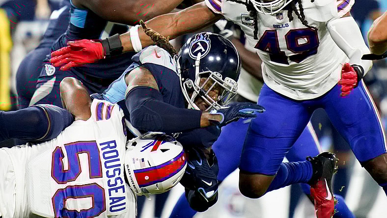 Tennessee Titans running back Derrick Henry (22) is tackled by Buffalo Bills defensive end Greg Rousseau (50) and middle linebacker Tremaine Edmunds (49) at Nissan Stadium Monday, Oct. 18, 2021 in Nashville, Tenn.