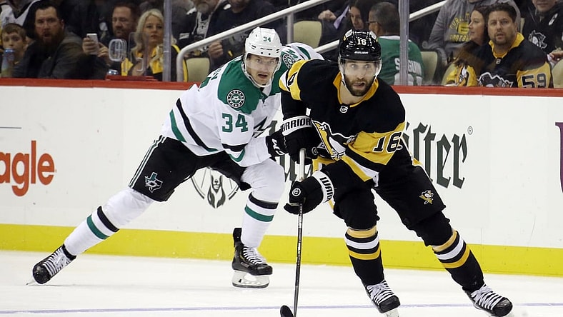 Oct 19, 2021; Pittsburgh, Pennsylvania, USA;  Pittsburgh Penguins left wing Jason Zucker (16) sites up ice with the puck ahead of Dallas Stars right wing Denis Gurianov (34) during the second period at PPG Paints Arena. Mandatory Credit: Charles LeClaire-USA TODAY Sports