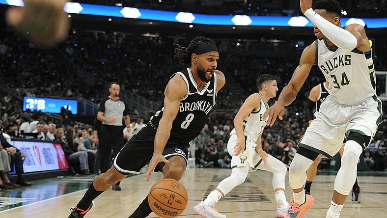 Oct 19, 2021; Milwaukee, Wisconsin, USA;  Brooklyn Nets guard Patty Mills (8) drives to the basket against Milwaukee Bucks forward Giannis Antetokounmpo (34) in the first half at Fiserv Forum. Mandatory Credit: Michael McLoone-USA TODAY Sports