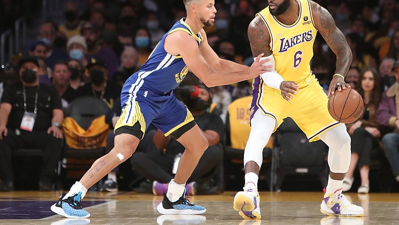 Oct 19, 2021; Los Angeles, California, USA; Los Angeles Lakers forward LeBron James (6) dribbles a ball against Golden State Warriors guard Stephen Curry (30) during the first quarter at Staples Center. Mandatory Credit: Kiyoshi Mio-USA TODAY Sports