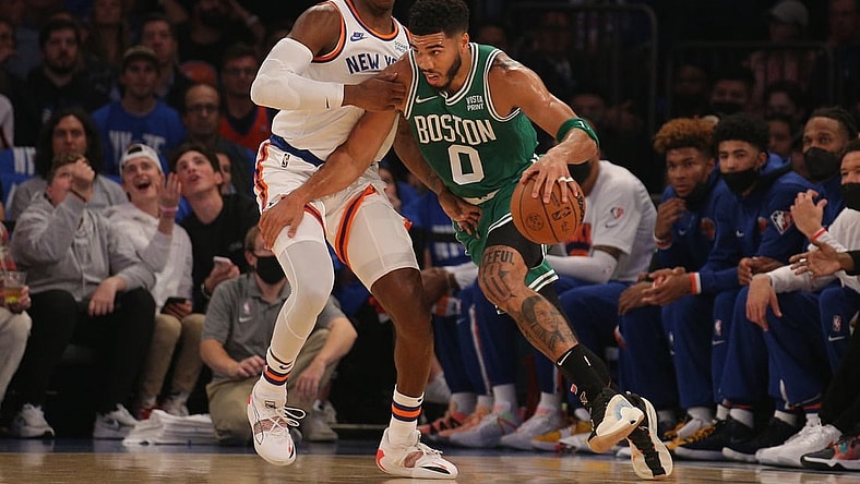 Oct 20, 2021; New York, New York, USA; Boston Celtics forward Jayson Tatum (0) controls the ball against New York Knicks guard RJ Barrett (9) during the first quarter at Madison Square Garden. Mandatory Credit: Brad Penner-USA TODAY Sports