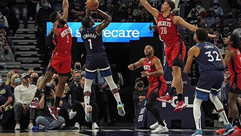 Oct 20, 2021; Minneapolis, Minnesota, USA; Minnesota Timberwolves forward Anthony Edwards (1) takes a jump shot as Houston Rockets forward David Nwaba (2) and center Alperen Sengun (28) defend during the first quarter at Target Center. Mandatory Credit: Nick Wosika-USA TODAY Sports