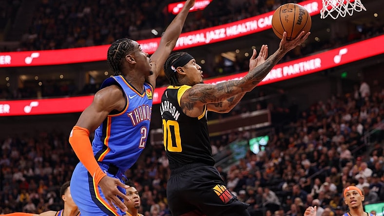 Oct 20, 2021; Salt Lake City, Utah, USA; Utah Jazz guard Jordan Clarkson (00) gets past Oklahoma City Thunder guard Shai Gilgeous-Alexander (2) and to the basket during the second quarter at Vivint Arena. Mandatory Credit: Chris Nicoll-USA TODAY Sports