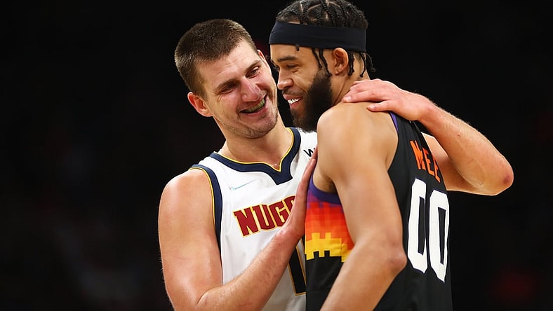 Oct 20, 2021; Phoenix, Arizona, USA; Denver Nuggets center Nikola Jokic (left) greets Phoenix Suns center JaVale McGee in the first half at Footprint Center. Mandatory Credit: Mark J. Rebilas-USA TODAY Sports