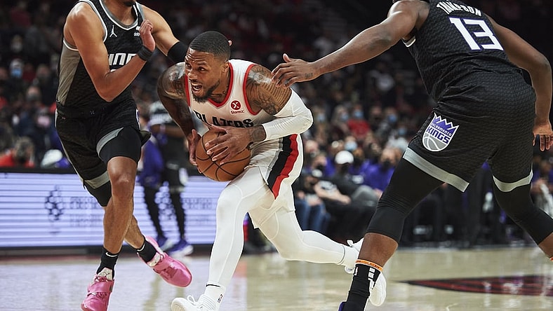 Oct 20, 2021; Portland, Oregon, USA; Portland Trail Blazers guard Damian Lillard (0) drives to the basket during the first half against Sacramento Kings guard Tyrese Haliburton (0) and center Tristan Thompson (13) at Moda Center. Mandatory Credit: Troy Wayrynen-USA TODAY Sports