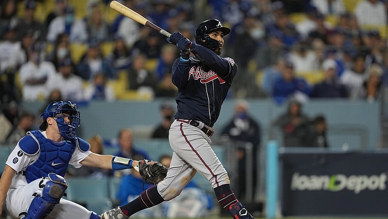 Oct 20, 2021; Los Angeles, California, USA; Atlanta Braves left fielder Eddie Rosario (8) hits a three run home run in the ninth inning against the Los Angeles Dodgers during game four of the 2021 NLCS at Dodger Stadium. Mandatory Credit: Kirby Lee-USA TODAY Sports