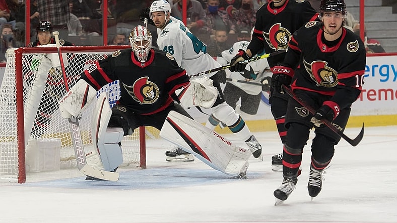 Oct 21, 2021; Ottawa, Ontario, CAN; Ottawa Senators goalie Matt Murray (30) defeseman Josh Brown (3) and left wing Alex Formenton (10) follow the puck in the first period against the San Jose Sharks at the Canadian Tire Centre. Mandatory Credit: Marc DesRosiers-USA TODAY Sports