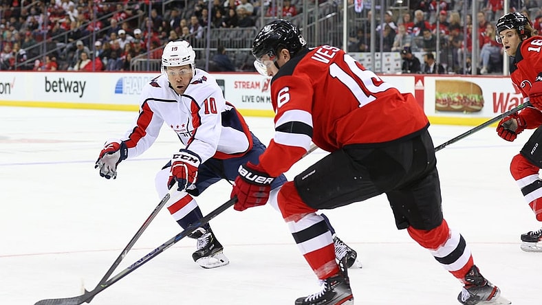 Oct 21, 2021; Newark, New Jersey, USA; New Jersey Devils left wing Jimmy Vesey (16) plays the puck while being defended by Washington Capitals right wing Daniel Sprong (10) during the first period at Prudential Center. Mandatory Credit: Ed Mulholland-USA TODAY Sports