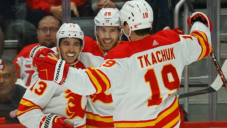 Oct 21, 2021; Detroit, Michigan, USA; Calgary Flames center Elias Lindholm (28) receives congratulations from teammates after scoring in the first period against the Detroit Red Wings at Little Caesars Arena. Mandatory Credit: Rick Osentoski-USA TODAY Sports