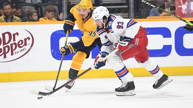 Oct 21, 2021; Nashville, Tennessee, USA; New York Rangers center Mika Zibanejad (93) handles the puck with pressure from Nashville Predators center Matt Duchene (95) during the second period at Bridgestone Arena. Mandatory Credit: Christopher Hanewinckel-USA TODAY Sports