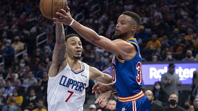 October 21, 2021; San Francisco, California, USA; Golden State Warriors guard Stephen Curry (30) passes the basketball against LA Clippers guard Amir Coffey (7) during the second quarter at Chase Center. Mandatory Credit: Kyle Terada-USA TODAY Sports