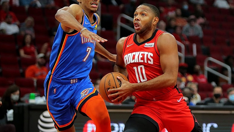 Oct 22, 2021; Houston, Texas, USA; Houston Rockets guard Eric Gordon (10, right) drives to the basket while Oklahoma City Thunder forward Darius Bazley (7, left) defends during the first quarter at Toyota Center. Mandatory Credit: Erik Williams-USA TODAY Sports