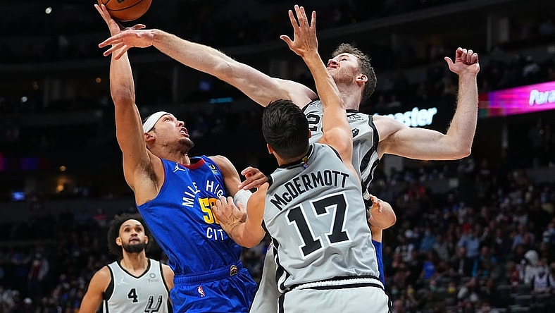 Oct 22, 2021; Denver, Colorado, USA; Denver Nuggets forward Aaron Gordon (50) shoots the ball at San Antonio Spurs center Jakob Poeltl (25) and forward Doug McDermott (17) in the first quarter at Ball Arena. Mandatory Credit: Ron Chenoy-USA TODAY Sports