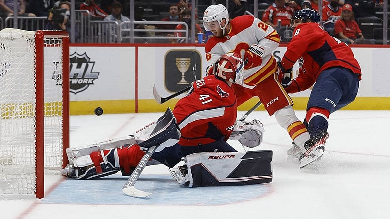 Oct 23, 2021; Washington, District of Columbia, USA; Calgary Flames center Elias Lindholm (28) scores a goal on Washington Capitals goaltender Vitek Vanecek (41) during the first period at Capital One Arena. Mandatory Credit: Geoff Burke-USA TODAY Sports