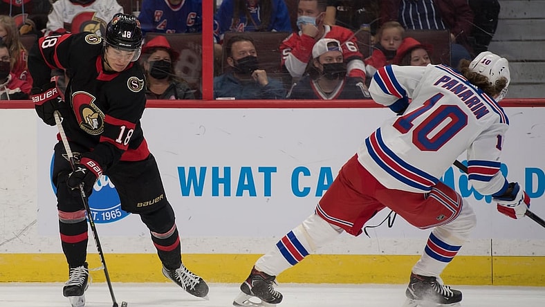 Oct 23, 2021; Ottawa, Ontario, CAN; Ottawa Senators left wing Tim St tzle (18) skates with the puck away from New York Rangers left wing Artemi Panarin (10) in the first period at the Canadian Tire Centre. Mandatory Credit: Marc DesRosiers-USA TODAY Sports