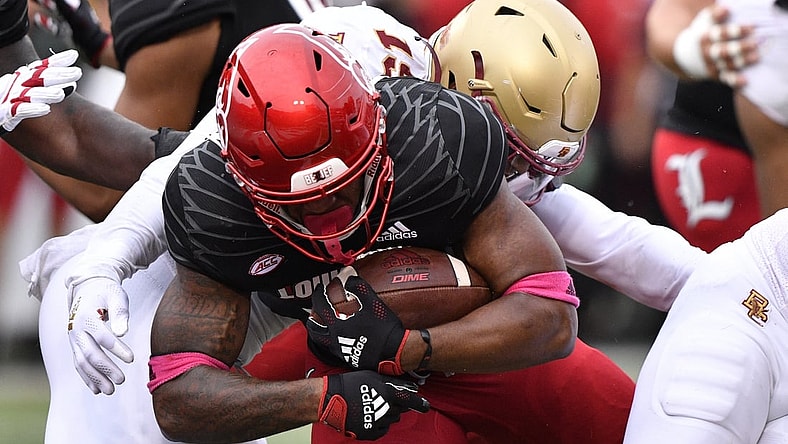Oct 23, 2021; Louisville, Kentucky, USA;  Louisville Cardinals running back Jalen Mitchell (15) pushes past Boston College Eagles linebacker Isaiah Graham-Mobley (19) to score a touchdown during the second quarter of play at Cardinal Stadium. Mandatory Credit: Jamie Rhodes-USA TODAY Sports