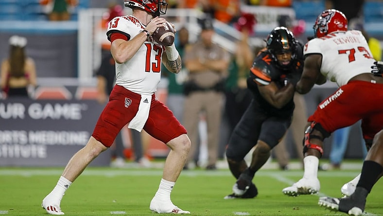 Oct 23, 2021; Miami Gardens, Florida, USA; North Carolina State Wolfpack quarterback Devin Leary (13) prepares to throws a pass against the Miami Hurricanes during the first quarter of the game at Hard Rock Stadium. Mandatory Credit: Sam Navarro-USA TODAY Sports