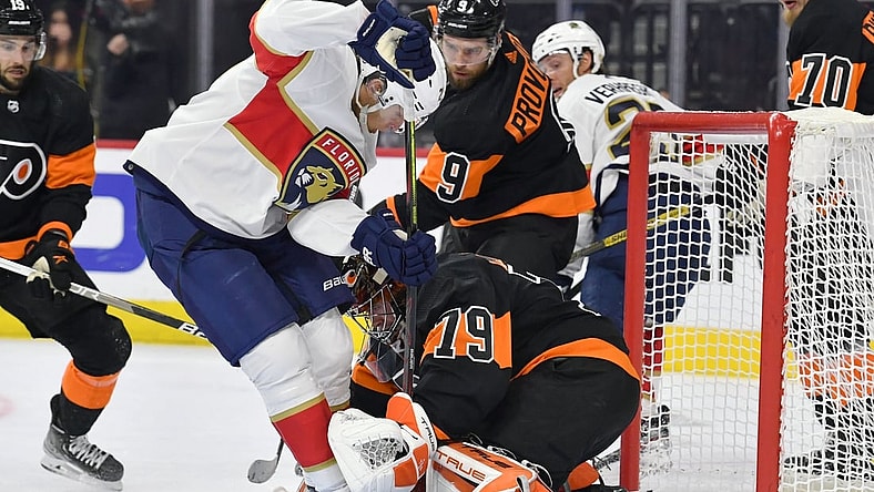 Oct 23, 2021; Philadelphia, Pennsylvania, USA;  Philadelphia Flyers goaltender Carter Hart (79) and  defenseman Ivan Provorov (9) hold off Florida Panthers center Eetu Luostarinen (27) during the second period at Wells Fargo Center. Mandatory Credit: Eric Hartline-USA TODAY Sports