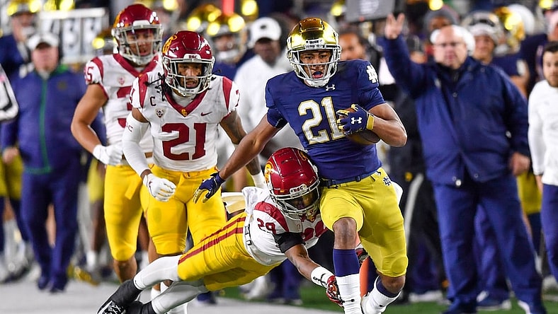 Oct 23, 2021; South Bend, Indiana, USA; Notre Dame Fighting Irish wide receiver Lorenzo Styles Jr. (21) runs the ball as USC Trojans safety Xavion Alford (29) attempts to tackle in the second quarter at Notre Dame Stadium. Mandatory Credit: Matt Cashore-USA TODAY Sports