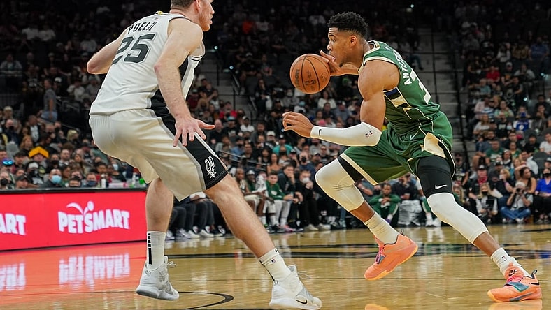 Oct 23, 2021; San Antonio, Texas, USA;  Milwaukee Bucks forward Giannis Antetokounmpo (34) dribbles against San Antonio Spurs center Jakob Poeltl (25) in the first half at the AT&T Center. Mandatory Credit: Daniel Dunn-USA TODAY Sports