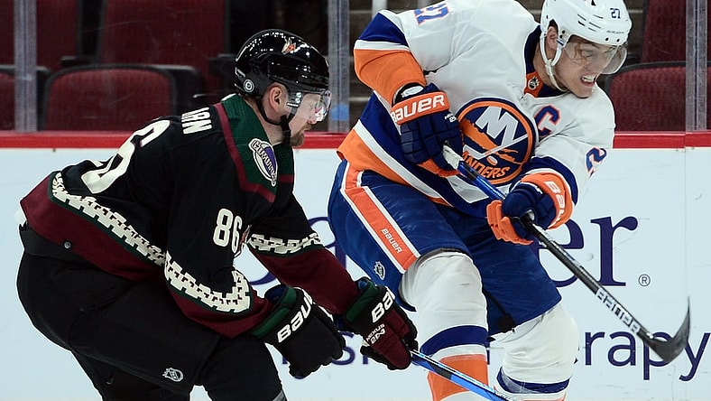 Oct 23, 2021; Glendale, Arizona, USA; New York Islanders center Anders Lee (27) shoots the puck against Arizona Coyotes defenseman Anton Stralman (86) during the first period at Gila River Arena. Mandatory Credit: Joe Camporeale-USA TODAY Sports