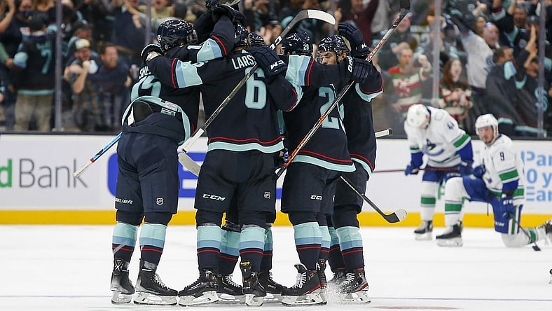 Oct 23, 2021; Seattle, Washington, USA; Seattle Kraken defenseman Vince Dunn (29) celebrates with teammates after scoring a goal against the Vancouver Canucks during the first period at Climate Pledge Arena. Mandatory Credit: Joe Nicholson-USA TODAY Sports