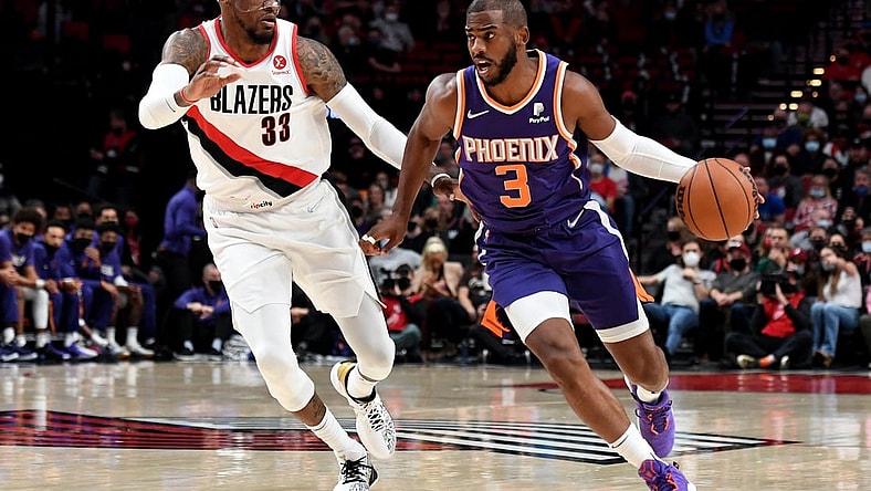 Oct 23, 2021; Portland, Oregon, USA; Phoenix Suns guard Chris Paul (3) dribbles the ball past Portland Trail Blazers forward Robert Covington (33) during the first quarter of the game at Moda Center. Mandatory Credit: Steve Dykes-USA TODAY Sports