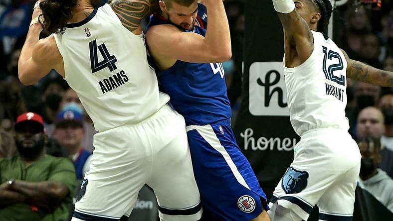 Oct 23, 2021; Los Angeles, California, USA;  Los Angeles Clippers center Ivica Zubac (40) fights off Memphis Grizzlies center Steven Adams (4) and Memphis Grizzlies guard Ja Morant (12) for a rebound in the first quarter of the game at Staples Center. Mandatory Credit: Jayne Kamin-Oncea-USA TODAY Sports