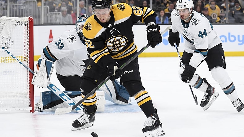 Oct 24, 2021; Boston, Massachusetts, USA;  Boston Bruins center Oskar Steen (62) controls the puck in front of San Jose Sharks goaltender Adin Hill (33) while defenseman Marc-Edouard Vlasic (44) defends during the first period at TD Garden. Mandatory Credit: Bob DeChiara-USA TODAY Sports