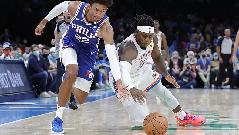 Oct 24, 2021; Oklahoma City, Oklahoma, USA; Philadelphia 76ers guard Matisse Thybulle (22) and Oklahoma City Thunder forward Luguentz Dort (5) dive for a loose ball during the second quarter at Paycom Center. Mandatory Credit: Alonzo Adams-USA TODAY Sports