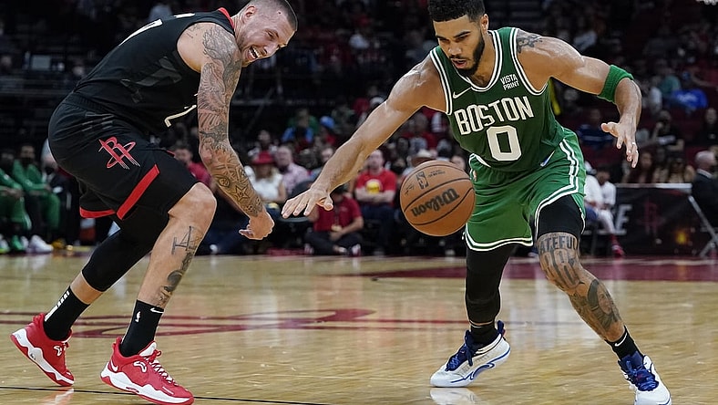 Oct 24, 2021; Houston, Texas, USA; Houston Rockets center Daniel Theis (27) and Boston Celtics forward Jayson Tatum (0) reach for a loose ball in the second quarter at Toyota Center. Mandatory Credit: Thomas Shea-USA TODAY Sports