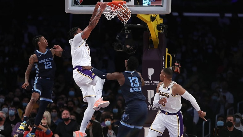 Oct 24, 2021; Los Angeles, California, USA; Los Angeles Lakers forward Anthony Davis (3) dunks over Memphis Grizzlies forward Jaren Jackson Jr. (13) during the first quarter at Staples Center. Mandatory Credit: Kiyoshi Mio-USA TODAY Sports