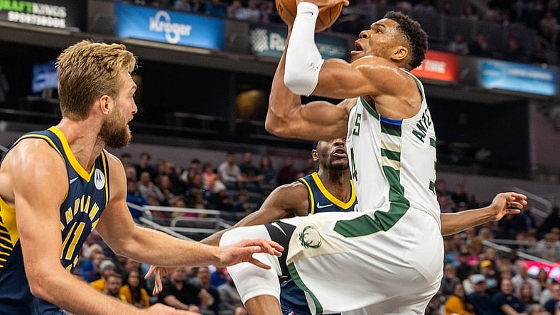Oct 25, 2021; Indianapolis, Indiana, USA; Milwaukee Bucks forward Giannis Antetokounmpo (34) shoots the ball while Indiana Pacers forward Domantas Sabonis (11) defends in the first quarter at Gainbridge Fieldhouse. Mandatory Credit: Trevor Ruszkowski-USA TODAY Sports