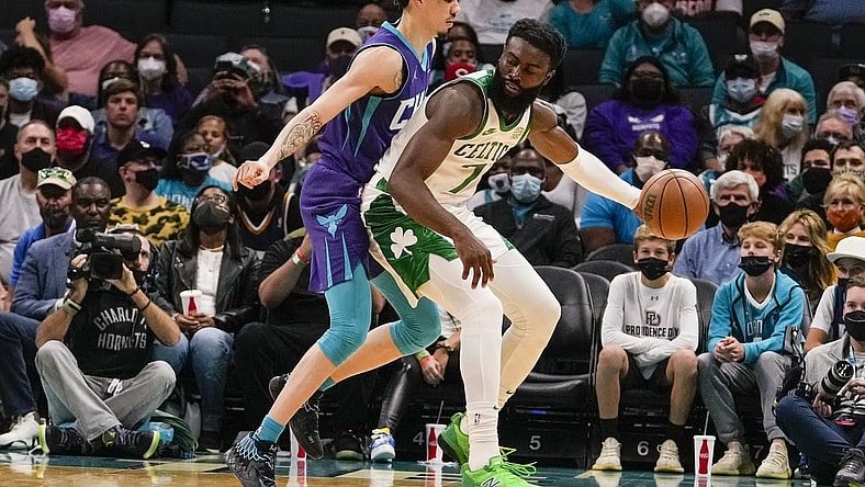 Oct 25, 2021; Charlotte, North Carolina, USA; Charlotte Hornets guard LaMelo Ball (2) defends Boston Celtics guard Jaylen Brown (7) during the first period at the Spectrum Center. Mandatory Credit: Jim Dedmon-USA TODAY Sports