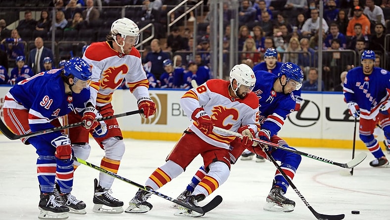 Oct 25, 2021; New York, New York, USA; Calgary Flames defenseman Oliver Kylington (58) and New York Rangers center Filip Chytil (72) fight for the puck during the first period at Madison Square Garden. Mandatory Credit: Danny Wild-USA TODAY Sports